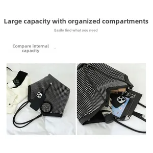 Detail view of a large black rhinestone tote bag showing ample interior storage space