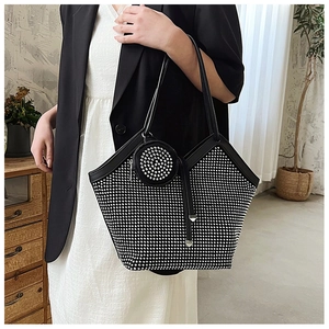 Detail of black tote bag with silver rhinestones and matching round coin purse pendant
