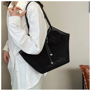Close-up of black tote bag with rhinestone mesh overlay and matching round coin purse detail