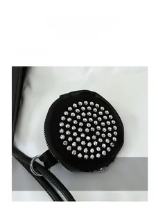 Detail of a round black leather coin purse with silver metal studs and punk style zipper