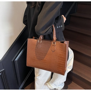 Detailed view of a brown crocodile pattern tote bag with large capacity and stiff structure