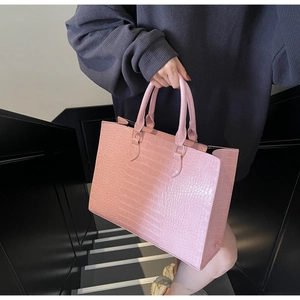 Detailed pink crocodile embossed texture on a large capacity stylish tote bag for women