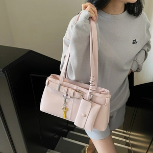 Pink glossy faux leather shoulder bag with decorative buckle and detachable coin purse