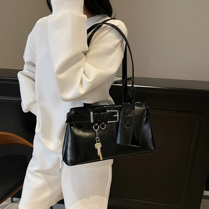 Minimalist black patent leather underarm shoulder bag with chic decorative metal buckle