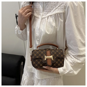 Crossbody view of brown printed square bag with golden H buckle and star pattern