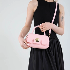 Chic pink candy-colored crossbody bag with gold metal buckle and top handle for women
