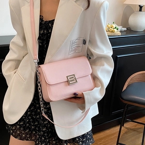 Retro light pink crossbody bag with silver S-lock and chain strap on a model