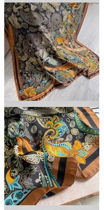 Detailed macro view of vintage paisley patterns and silk-like texture on a brown scarf