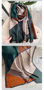 Detail view of the silk scarf featuring geometric color blocks and houndstooth pattern