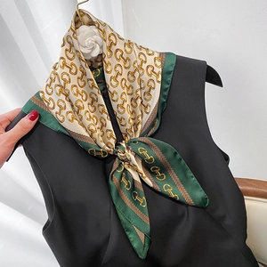 British style satin square scarf with green borders and golden horsebit chain patterns
