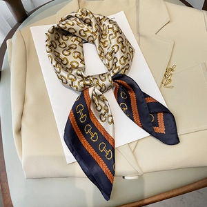 Elegant 70x70cm satin silk scarf with equestrian chain print on a beige blazer