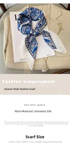 Close-up of blue paisley floral silk scarf styled on beige blazer with 70x70cm dimensions