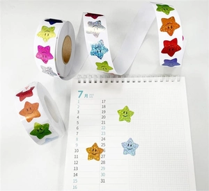 Détail d'autocollants étoiles souriantes colorées en rouleau et décoration de calendrier