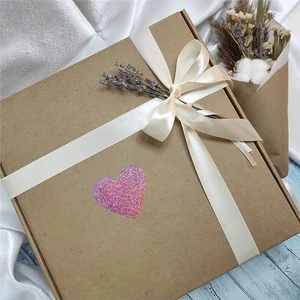 Pink heart laser sticker on kraft gift box with lavender and white satin ribbon