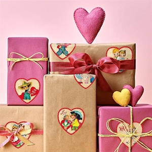 Detail of vintage heart-shaped Valentine stickers on gift boxes with romantic quotes