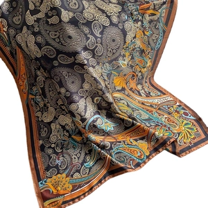 Classic paisley print silk shawl with satin finish on a white background