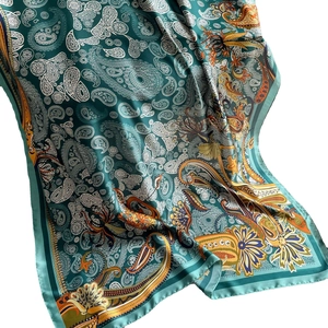 Luxurious deep teal paisley silk scarf with elegant drape and satin finish