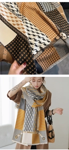 Detail of cashmere-like scarf with houndstooth pattern, geometric prints and fringe edges
