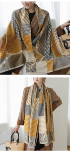 Detail of color-block scarf with houndstooth patterns and elegant fringe textures