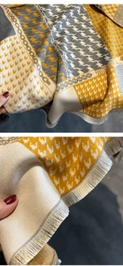 Detail of cashmere-like scarf showing fine fringe edges and houndstooth patchwork pattern