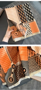 Close-up of houndstooth scarf with chain patterns and fringe details in autumn tones