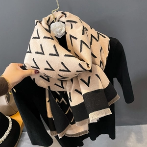 Thick beige winter shawl with black geometric V-patterns and elegant fringe details