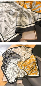 Macro view of silky floral square scarf showing elegant botanical patterns and edges