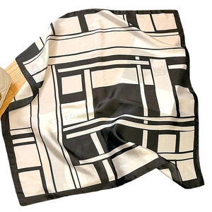 Classic black and white geometric square silk scarf with a smooth satin finish shown flat