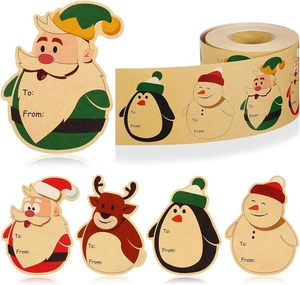 Detail of kraft Christmas gift stickers with Santa and penguin on a roll for labeling