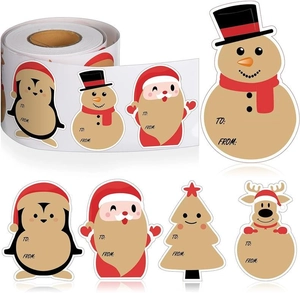Close-up of roll-packed Christmas gift tags with Santa and snowman for gift wrapping