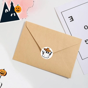 1-inch Halloween ghost stickers with cowboy hats on a brown paper envelope