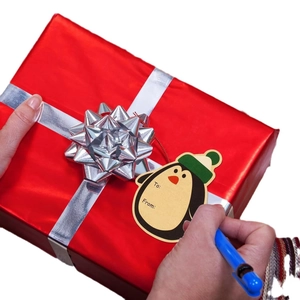 Cartoon penguin Christmas gift tags with To and From fields for holiday wrapping