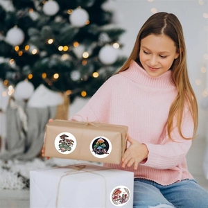 Close-up of cartoon mushroom and frog stickers decorating a gift box for a festive look