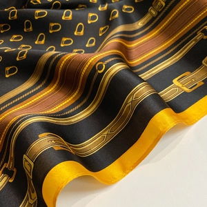 Detailed view of silk square scarf featuring classic equestrian belt and buckle patterns