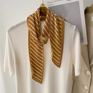 Pleated striped silk scarf in mustard yellow and white on white short sleeve shirt