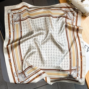Detailed view of the silk scarf featuring equestrian prints and fine stitched edges