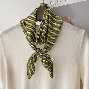 Pleated army green striped scarf on beige sweater for a classy neck decoration