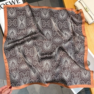 Detail of silk square scarf featuring vintage baroque paisley prints and bronze border