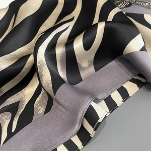 Close-up of zebra print silk scarf showing soft fabric texture and glossy finish