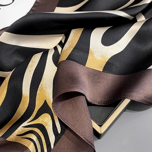 Detailed view of mulberry silk scarf with abstract zebra pattern and elegant glossy texture