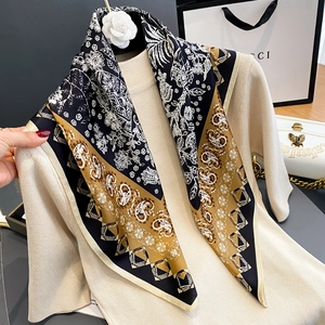 Silk square scarf with botanical chain patterns in black, white, and golden brown colors