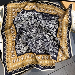 Silk square scarf featuring paisley patterns and floral chains in navy and yellow