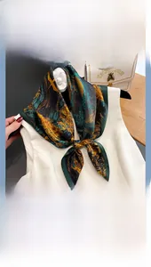 Detail of silk scarf with artistic oil painting pattern tied on white clothing neck