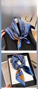 Detail of silk scarf with vintage chain patterns shown on a model and in gift packaging
