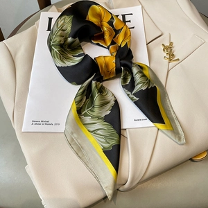 Floral silk square scarf with yellow roses and black background on a stylish suit