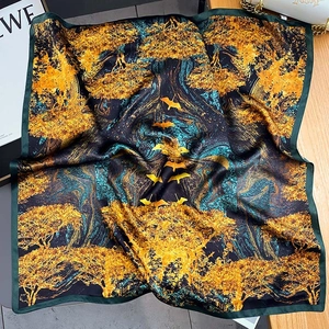 Luxurious silk scarf featuring a golden forest and birds print on a dark green base
