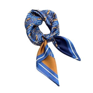 Fashionable twill silk square scarf with blue and brown chain print tied in a knot