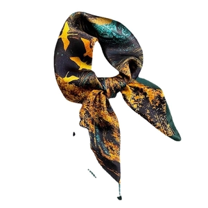 Vintage 65cm mulberry silk scarf with blue bird pattern on dark base tied in a bow