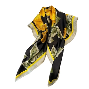 Elegant black silk square scarf featuring vibrant yellow roses and leaf pattern design