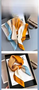 Detailed view of geometric mulberry silk scarf with colorful blocks and subtle silk texture